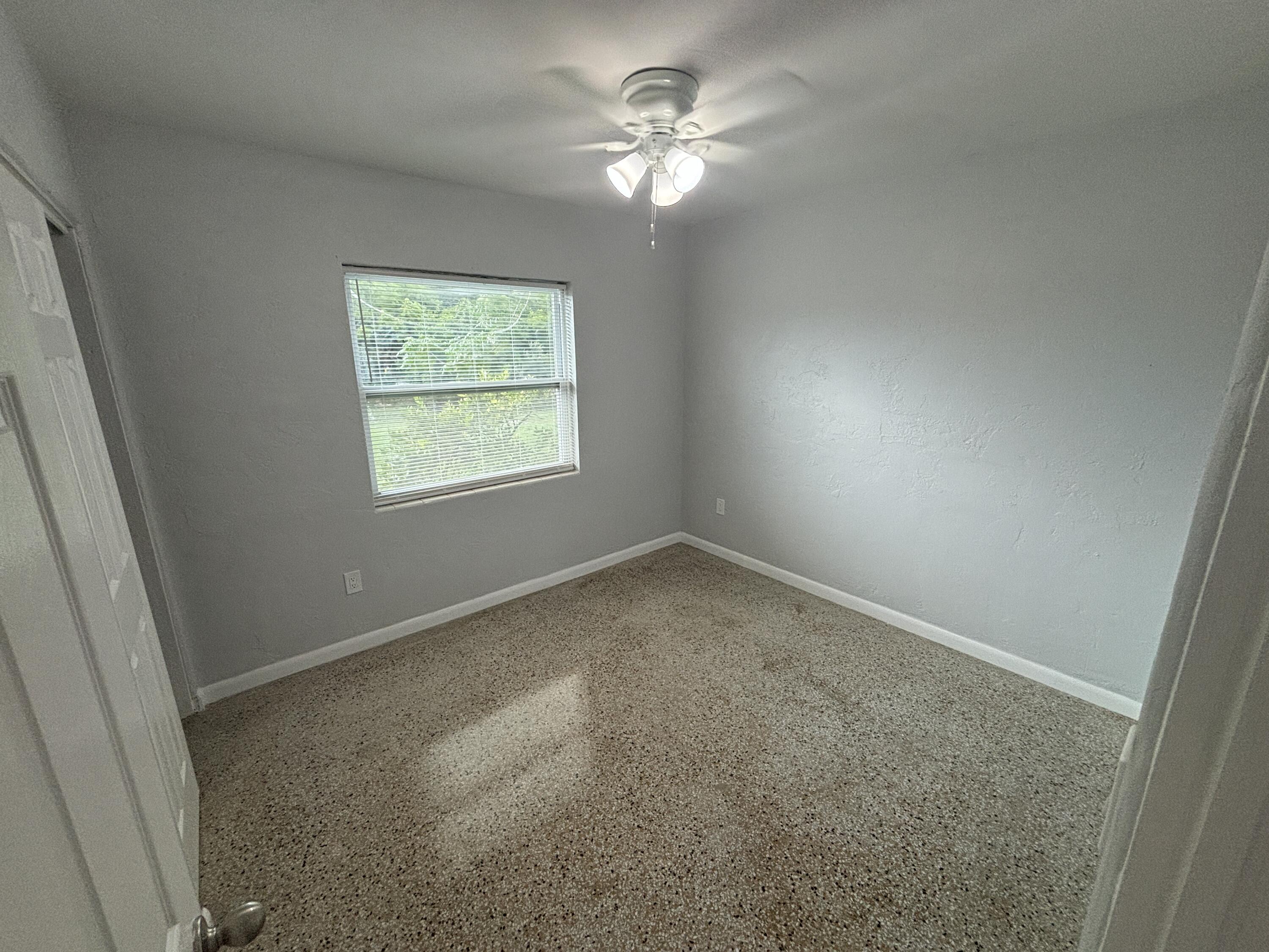 4305 Hammock Trail Mims, FL 32754 - Photo 12 of 16 an empty room with windows and fan
