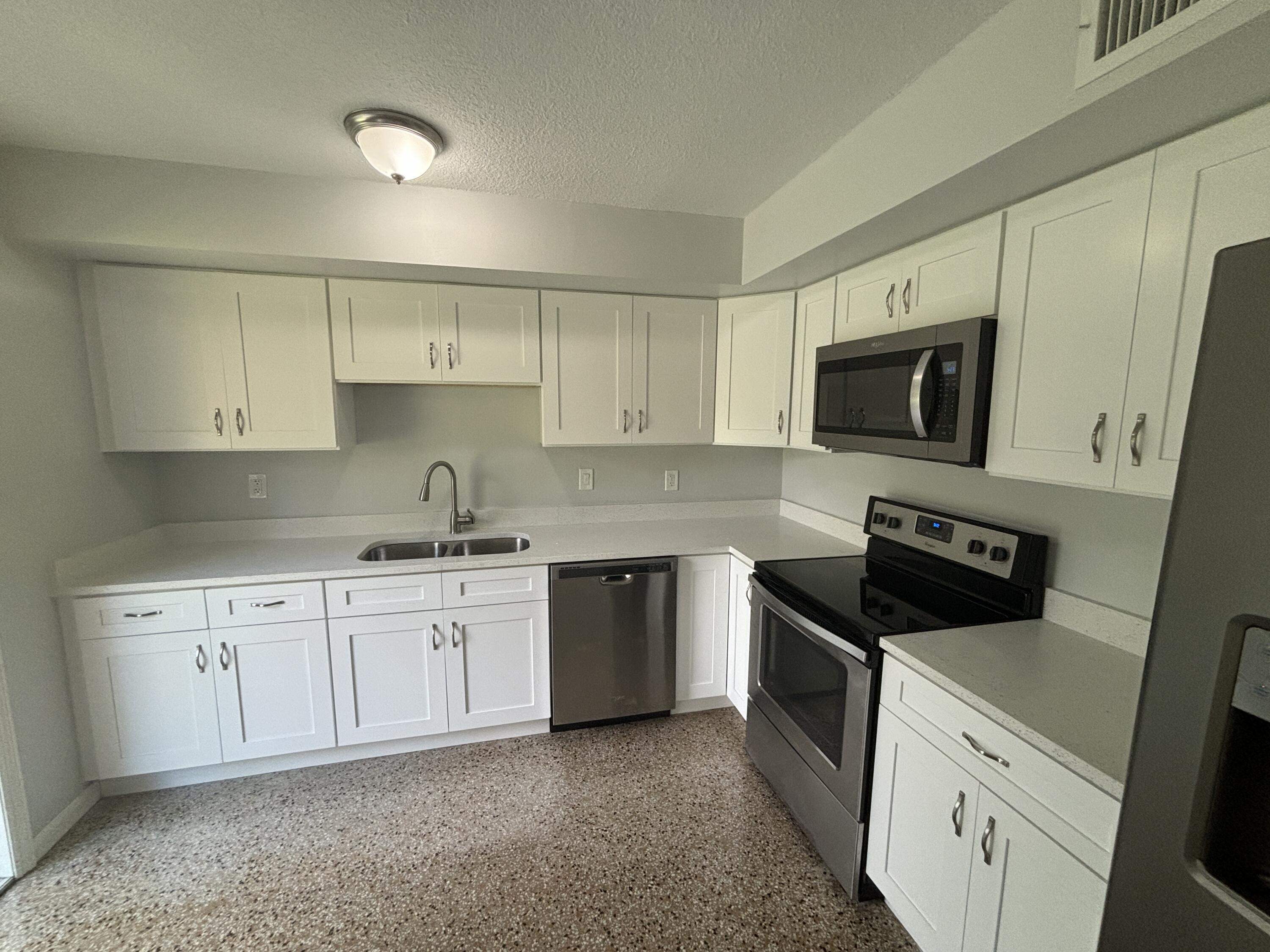 4305 Hammock Trail Mims, FL 32754 - Photo 6 of 16 a kitchen with a sink stove and microwave