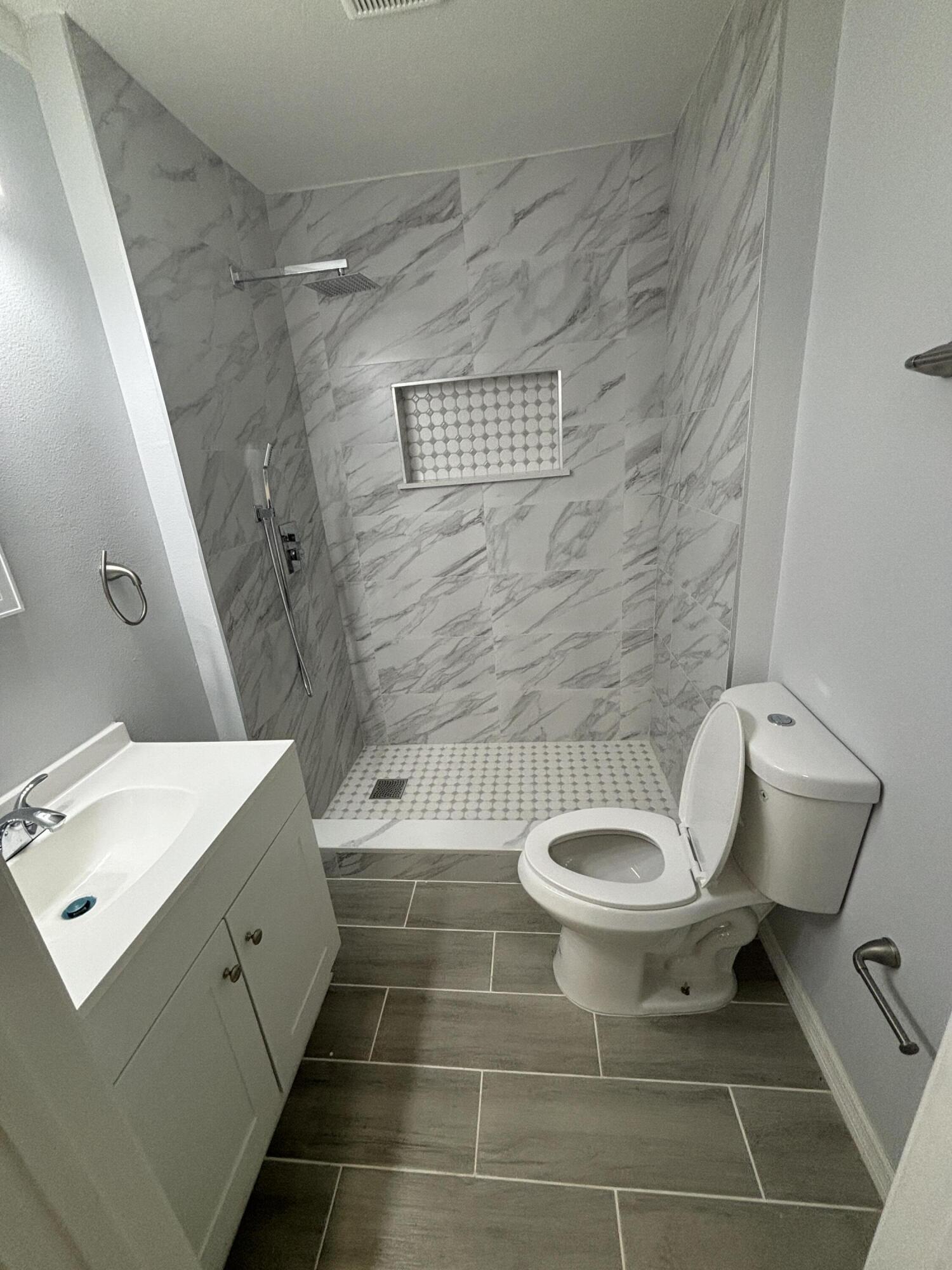 4305 Hammock Trail Mims, FL 32754 - Photo 10 of 16 a bathroom with a toilet and a sink