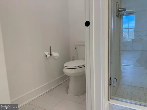 a bathroom with a toilet and a shower