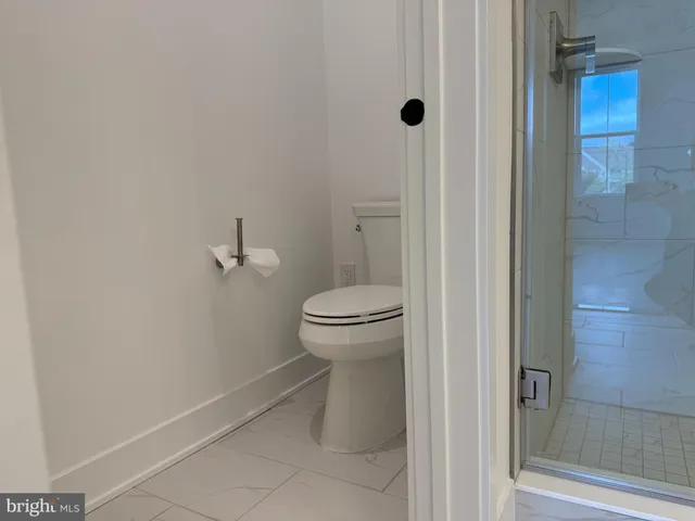 a bathroom with a toilet and a shower