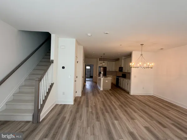 a view of a living room with wooden floor