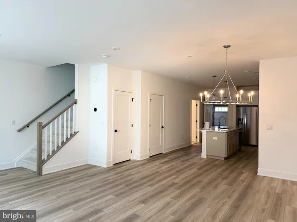a view of a room with wooden floor and staircase