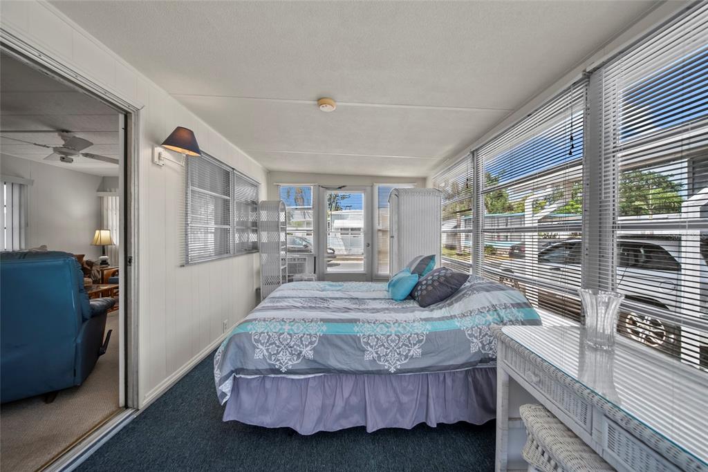 11047 102nd Way North, Unit 203 Largo, FL 33773 - Photo 11 of 26 a bedroom with a large bed and large windows