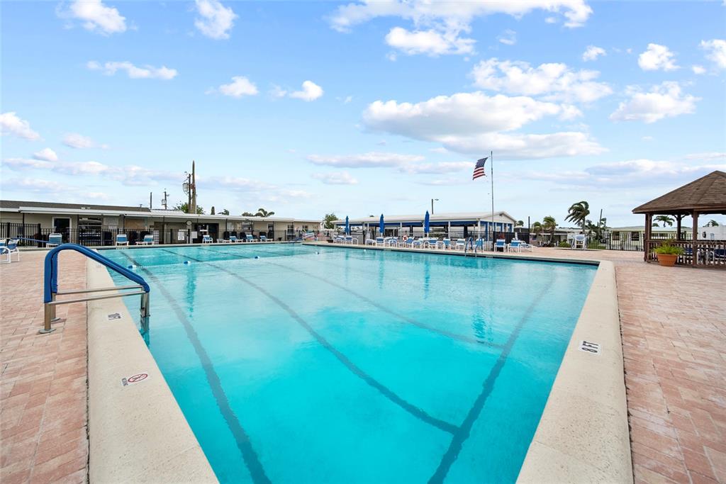 11047 102nd Way North, Unit 203 Largo, FL 33773 - Photo 19 of 26 a view of a swimming pool and an outdoor seating
