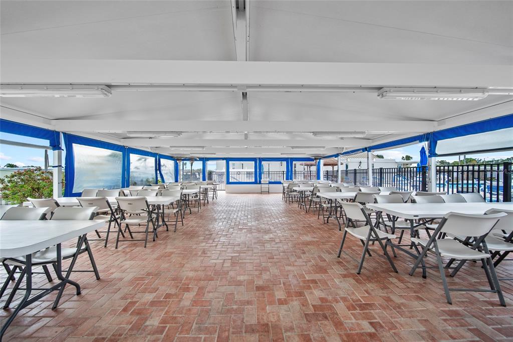 11047 102nd Way North, Unit 203 Largo, FL 33773 - Photo 25 of 26 a dining room with furniture and a floor to ceiling window