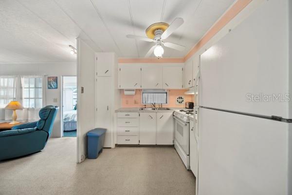 11047 102nd Way North, Unit 203 Largo, FL 33773 - Photo 5 of 26 a kitchen with refrigerator and cabinets