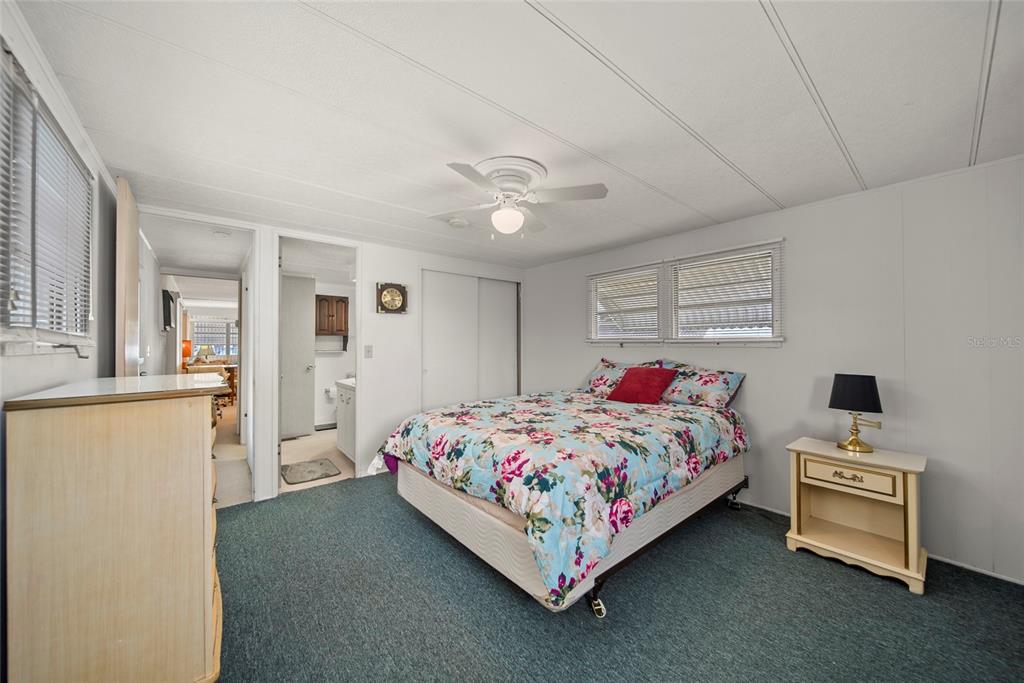 11047 102nd Way North, Unit 203 Largo, FL 33773 - Photo 7 of 26 a bedroom with a bed and a chandelier