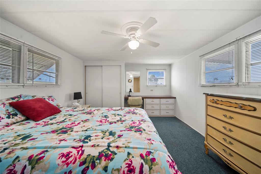 11047 102nd Way North, Unit 203 Largo, FL 33773 - Photo 8 of 26 a bedroom with a bed and wooden floor