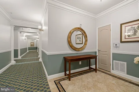 a kitchen with granite countertop a stove cabinets and wooden floor