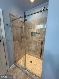 a bathroom with a glass shower door