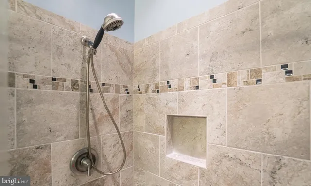 a bathroom with a bathtub and a shower