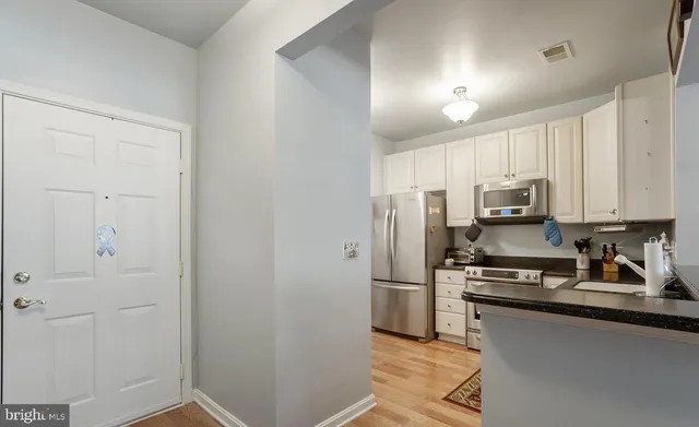 a kitchen with a refrigerator and a sink