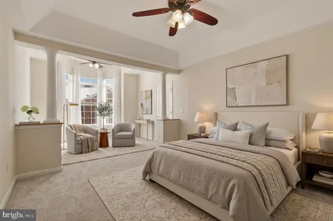 a spacious bedroom with a bed and a chandelier