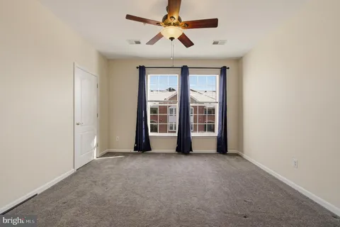 a view of a room with a ceiling fan