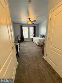 a view of a bedroom with a bed and a window