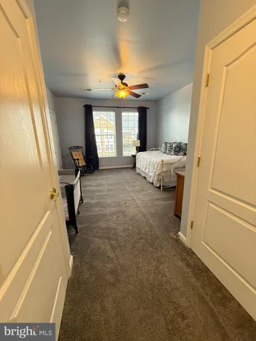 a view of a bedroom with a bed and a window