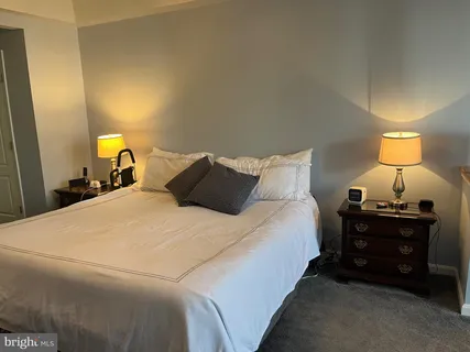 a bedroom with a bed and a lamp