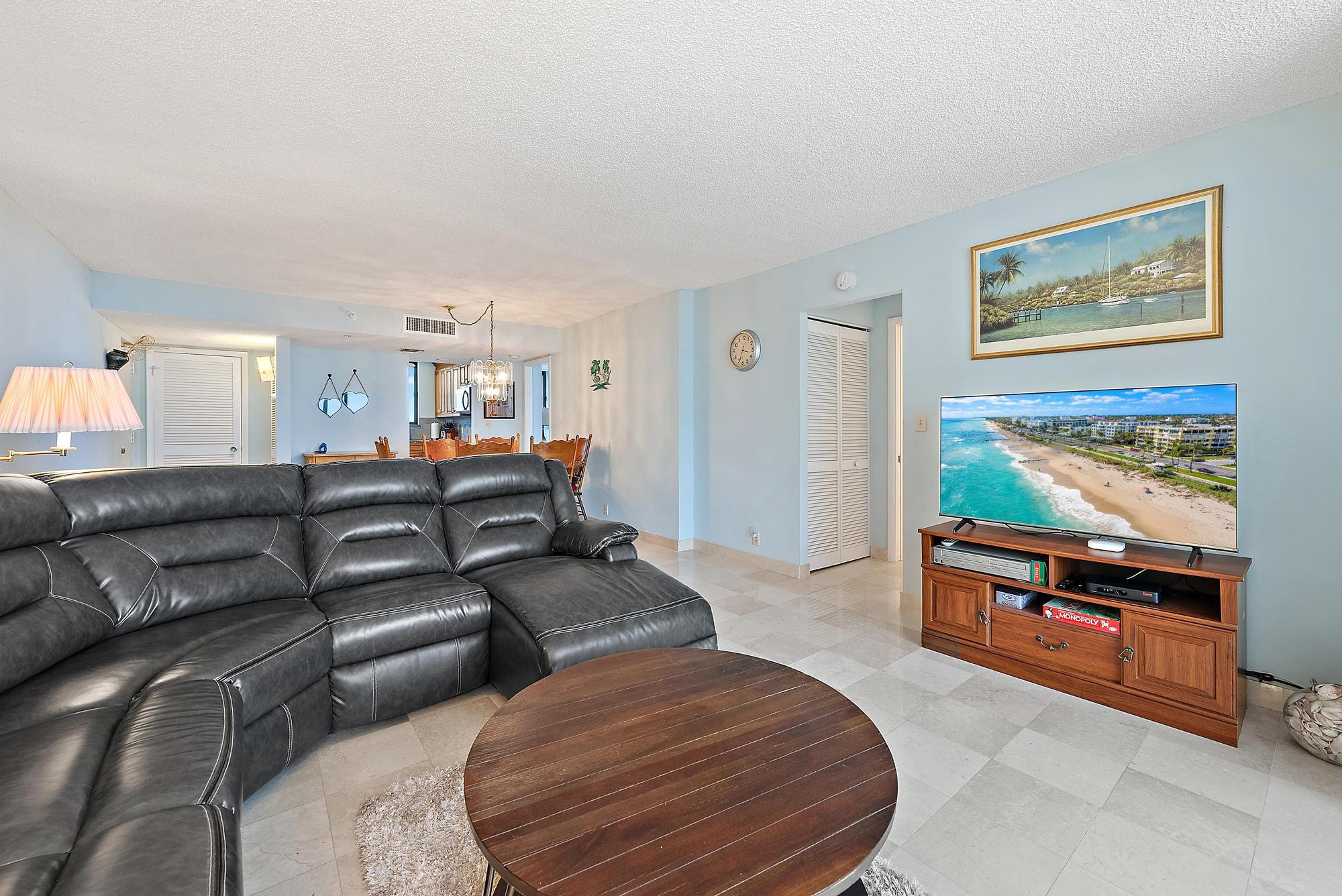 400 Ocean Trail Way, Unit 601 Jupiter, FL 33477 - Photo 24 of 42 a living room with furniture and a flat screen tv