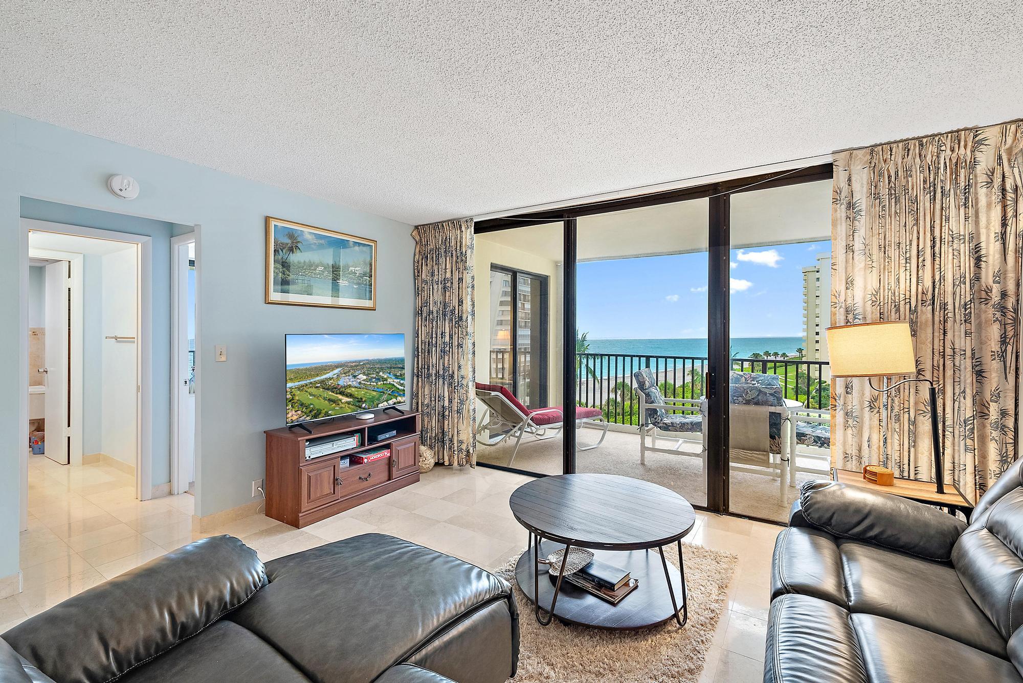 400 Ocean Trail Way, Unit 601 Jupiter, FL 33477 - Photo 25 of 42 a living room with furniture and a floor to ceiling window
