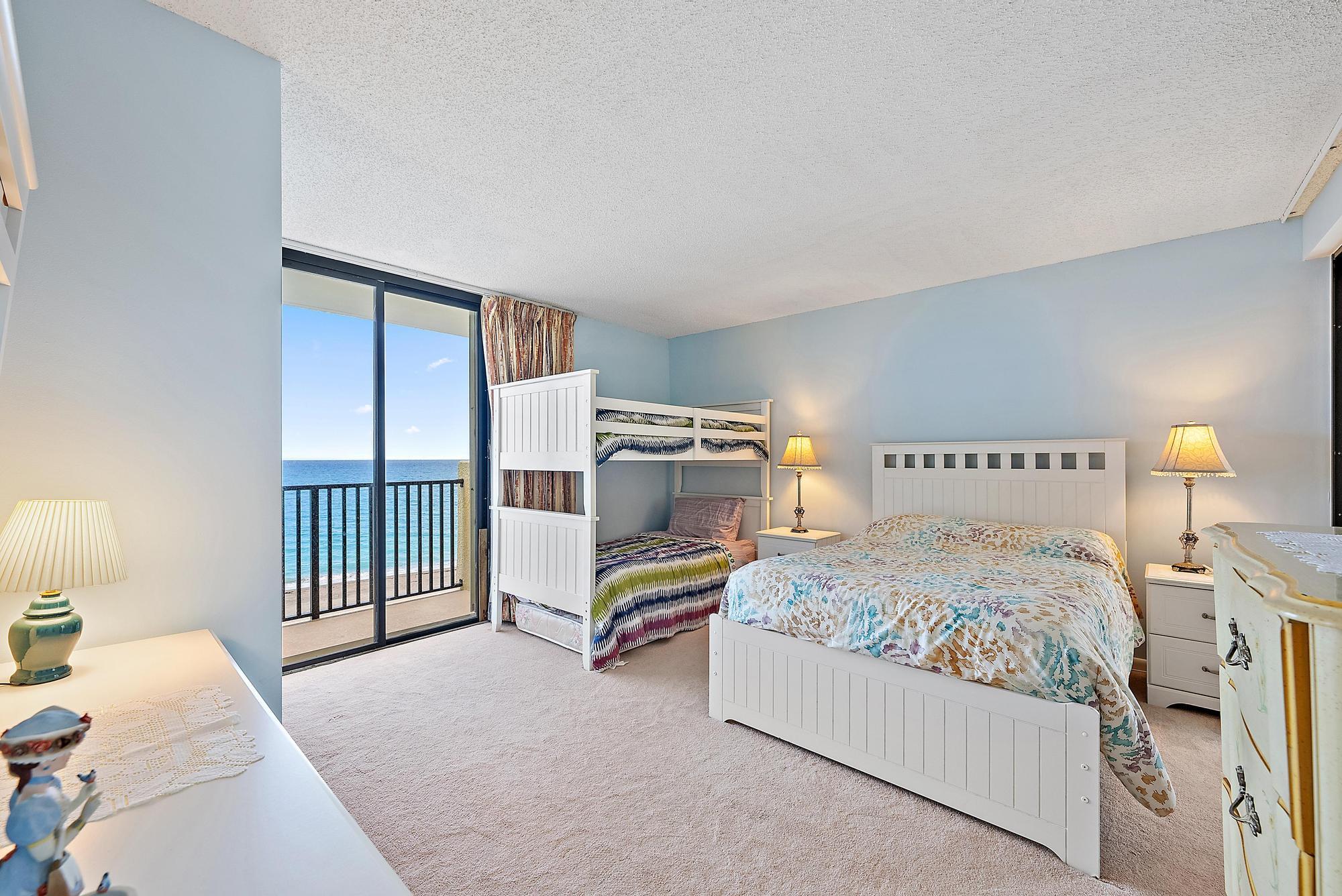 400 Ocean Trail Way, Unit 601 Jupiter, FL 33477 - Photo 30 of 42 a bedroom with a bed and a walk in closet