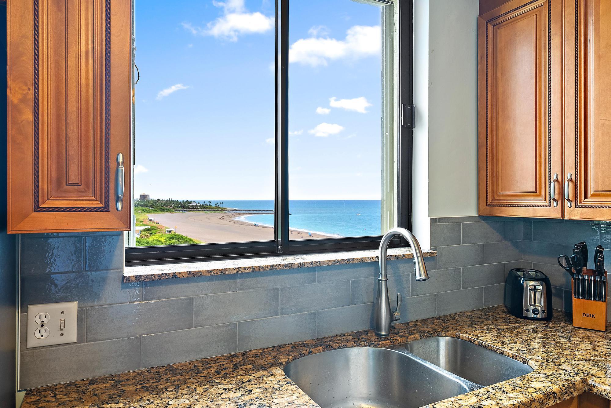 400 Ocean Trail Way, Unit 601 Jupiter, FL 33477 - Photo 33 of 42 a kitchen with granite countertop a sink and a window