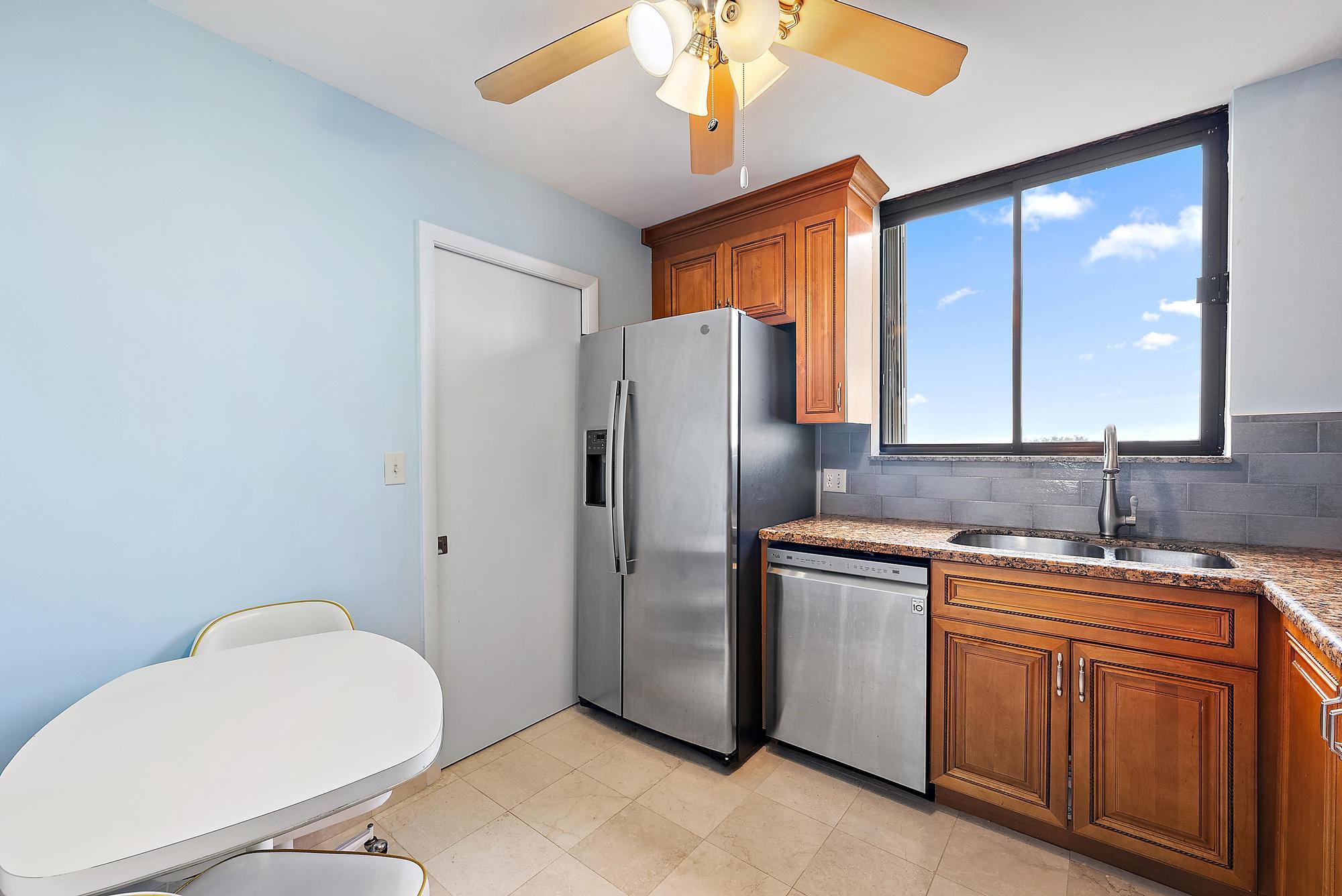 400 Ocean Trail Way, Unit 601 Jupiter, FL 33477 - Photo 35 of 42 a kitchen with stainless steel appliances a refrigerator and a sink