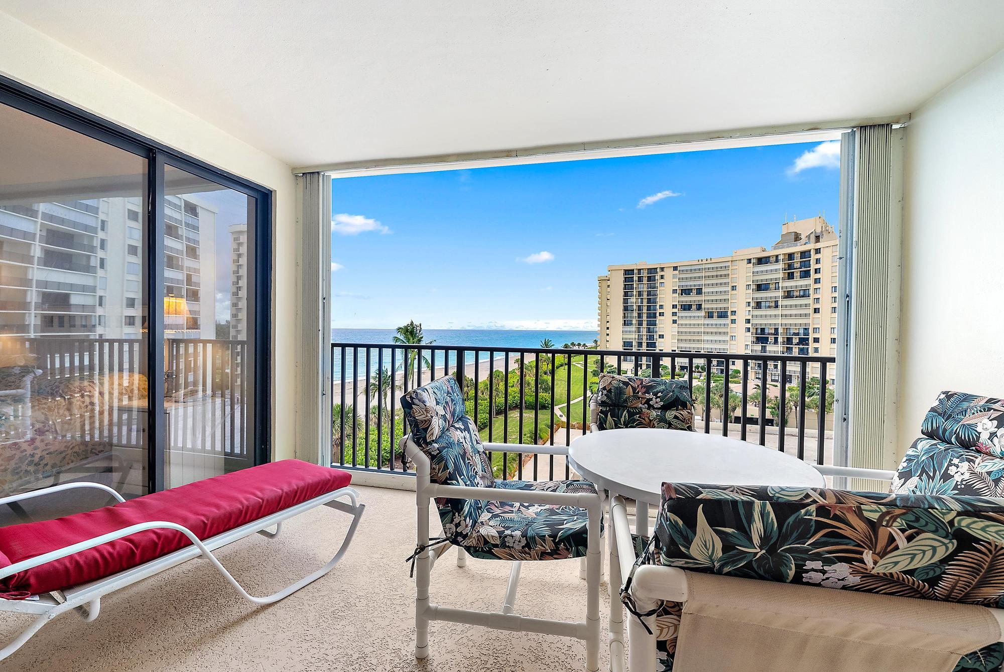 400 Ocean Trail Way, Unit 601 Jupiter, FL 33477 - Photo 36 of 42 a living room with furniture and a floor to ceiling window