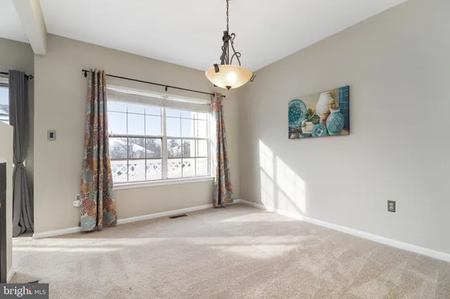 a view of livingroom with window ceiling fan and front door