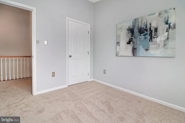 an empty room with windows and cabinet