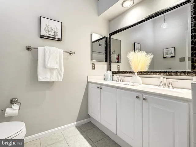 a view of a white house with a yard in front of it