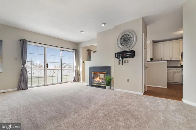 a view of a livingroom with a fireplace and a window