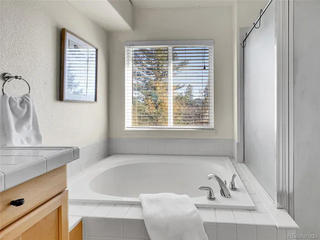 a bath tub sitting in a bathroom next to a window