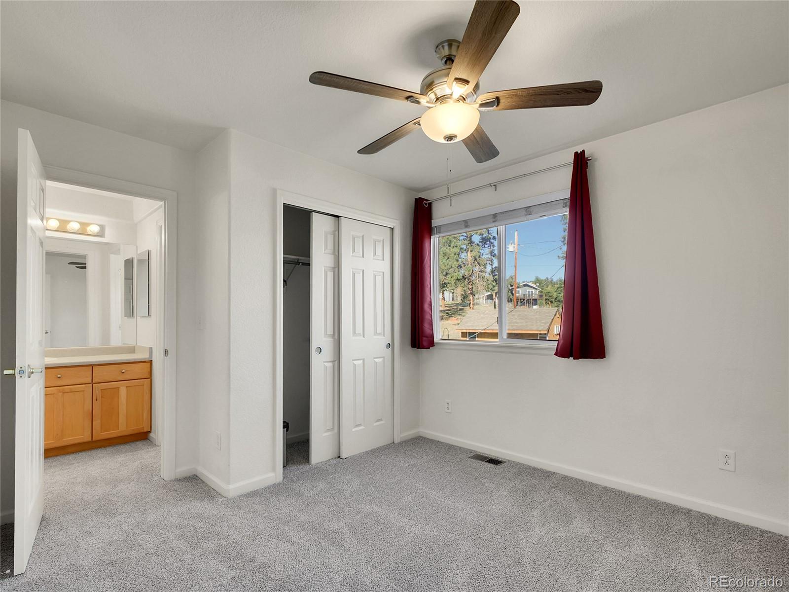 13586 Wamblee Trail Conifer, CO 80433 - Photo 16 of 38 an empty room with windows and fan