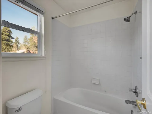 a bath tub sitting next to a window
