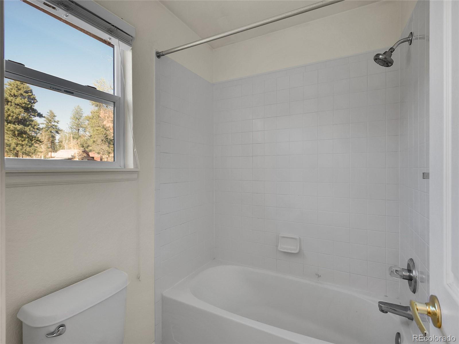 13586 Wamblee Trail Conifer, CO 80433 - Photo 18 of 38 a bath tub sitting next to a window