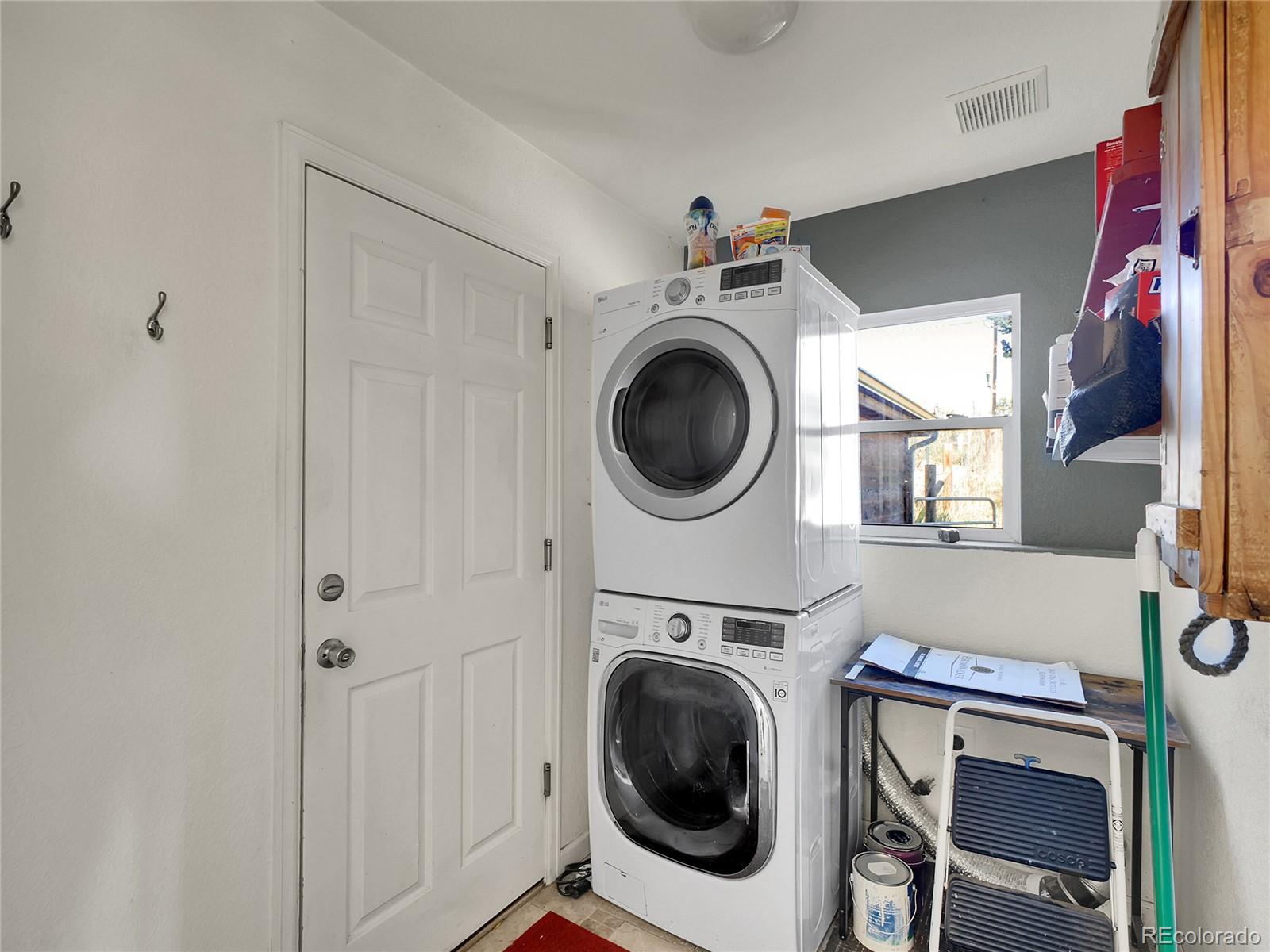 13586 Wamblee Trail Conifer, CO 80433 - Photo 20 of 38 a view of a hallway with washer and dryer