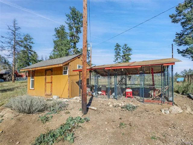 a view of a house with a backyard and tree