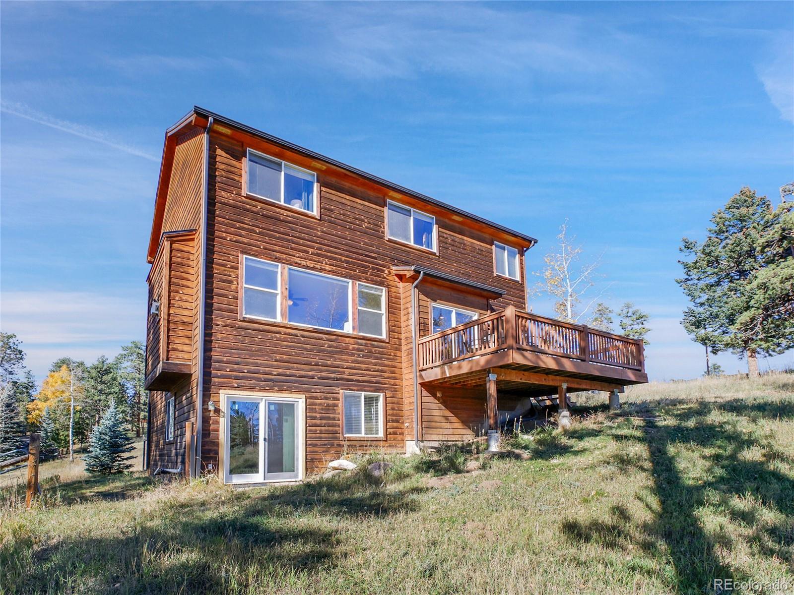 13586 Wamblee Trail Conifer, CO 80433 - Photo 27 of 38 a front view of a house with a yard