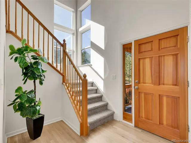 a view of staircase with wooden floor and a potted plant