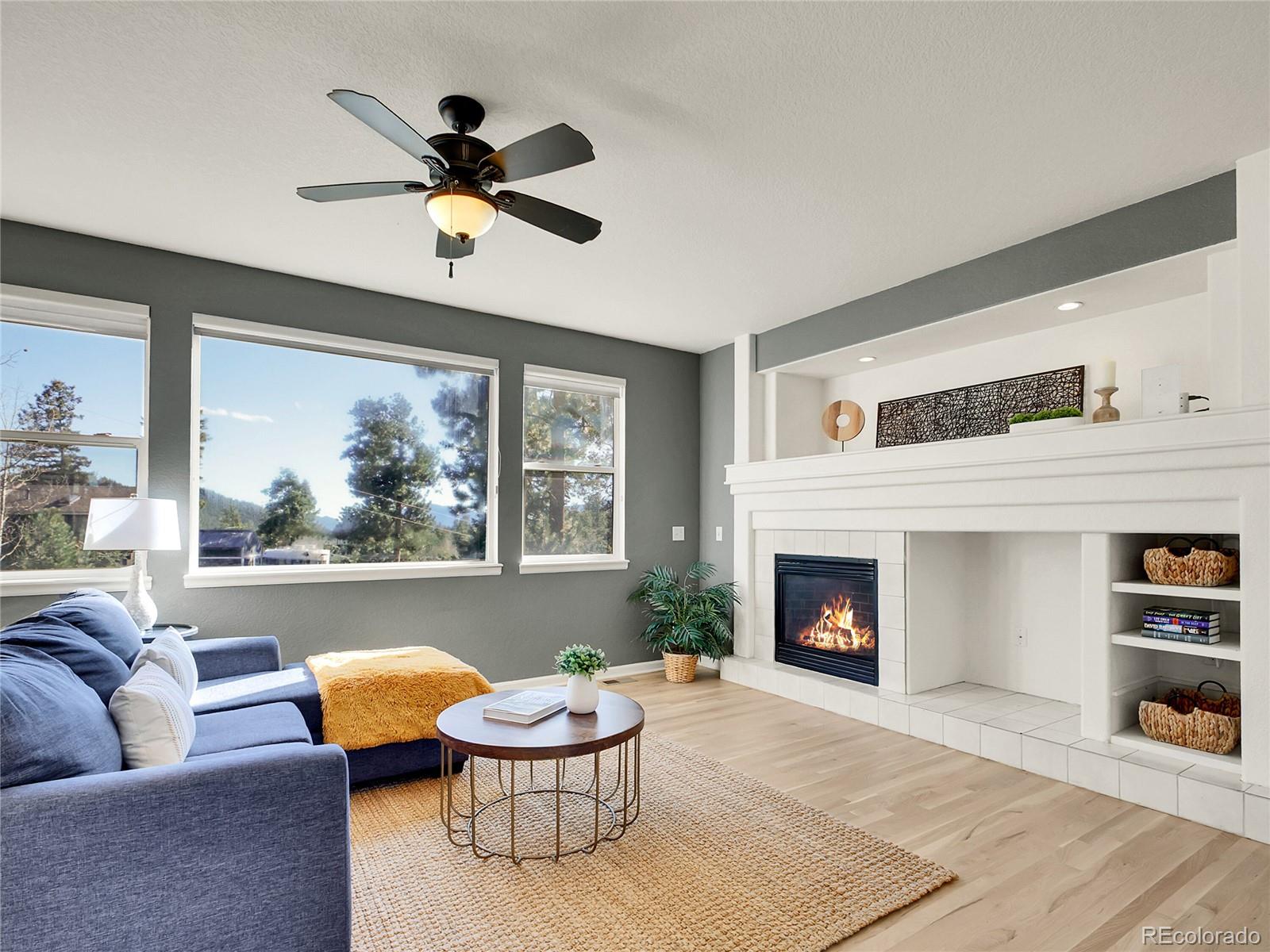 13586 Wamblee Trail Conifer, CO 80433 - Photo 5 of 38 a living room with furniture and a fireplace