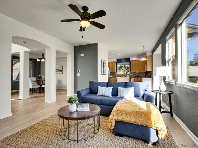a living room with furniture a rug and a large window