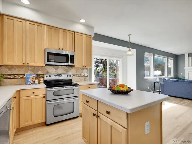 a kitchen with a stove a sink and a microwave