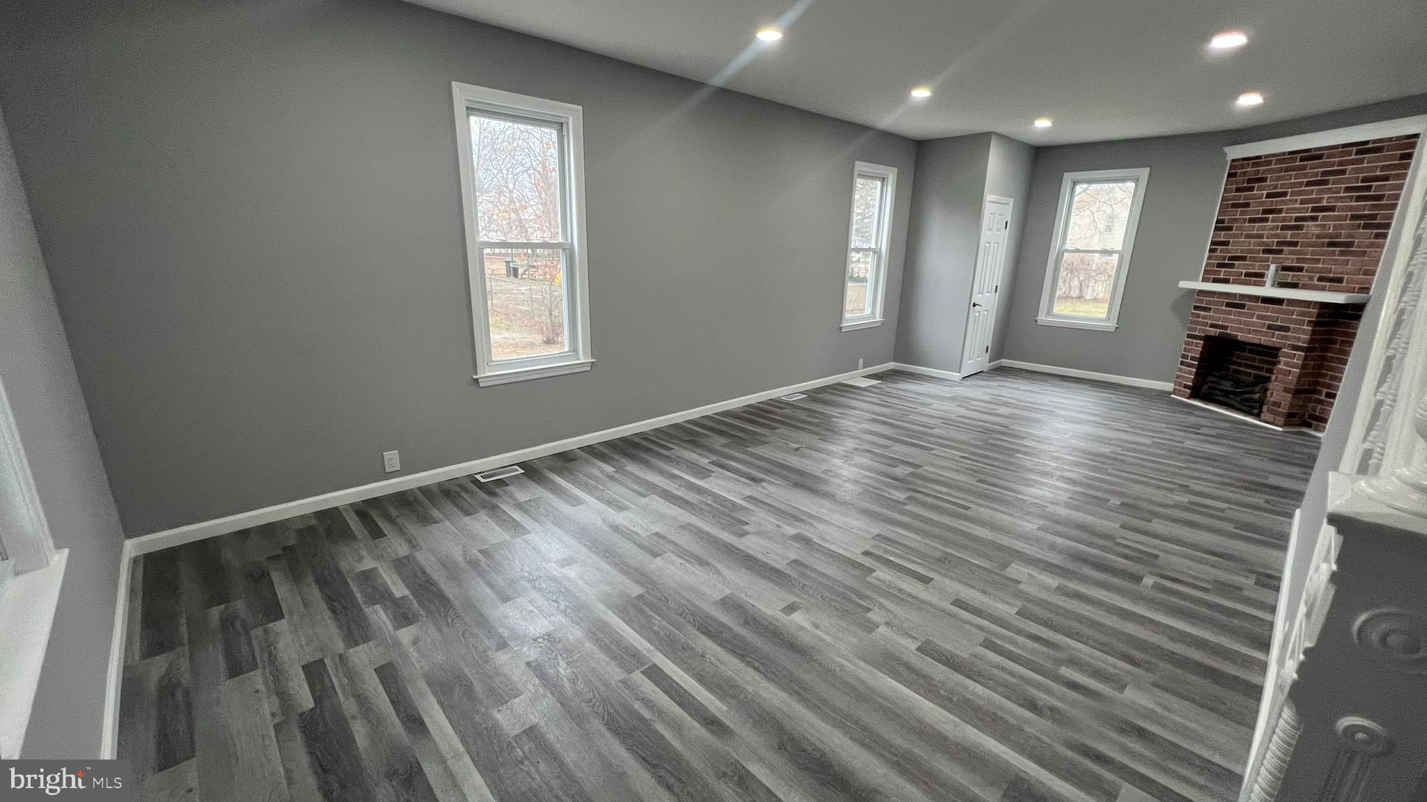 434 East Maple Avenue Lindenwold, NJ 08021 - Photo 7 of 36 a view of an empty room with wooden floor and a window
