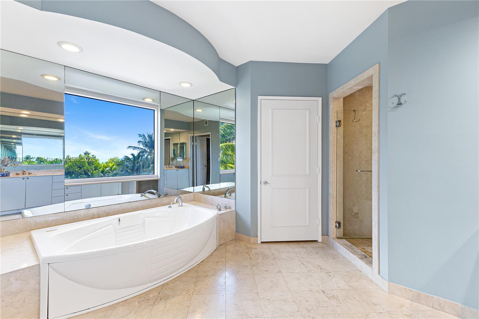 781 Crandon Boulevard, Unit 406 Key Biscayne, FL 33149 - Photo 12 of 35 a spacious bathroom with a tub and shower