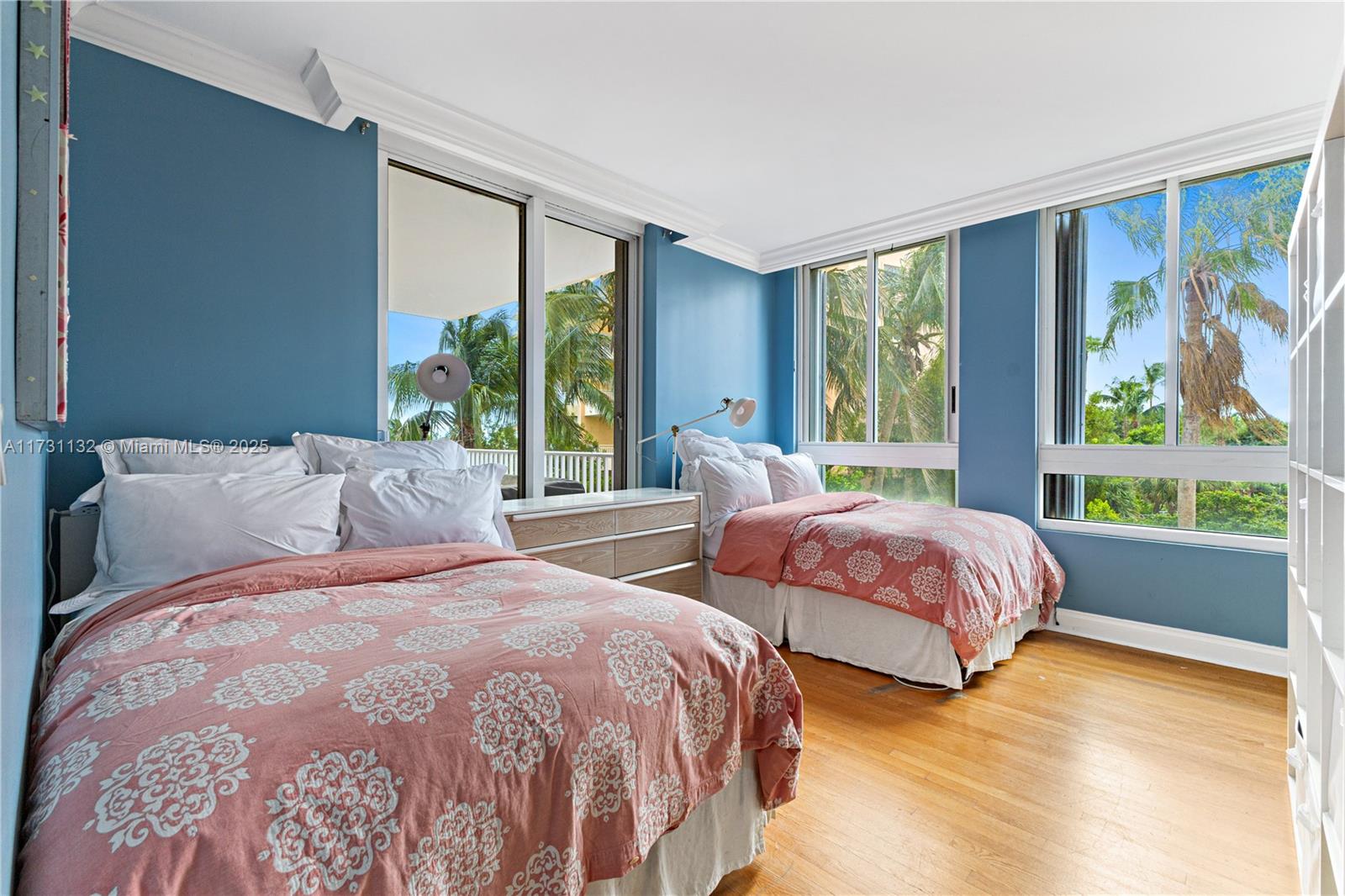 781 Crandon Boulevard, Unit 406 Key Biscayne, FL 33149 - Photo 13 of 35 a bedroom with two beds and a large window