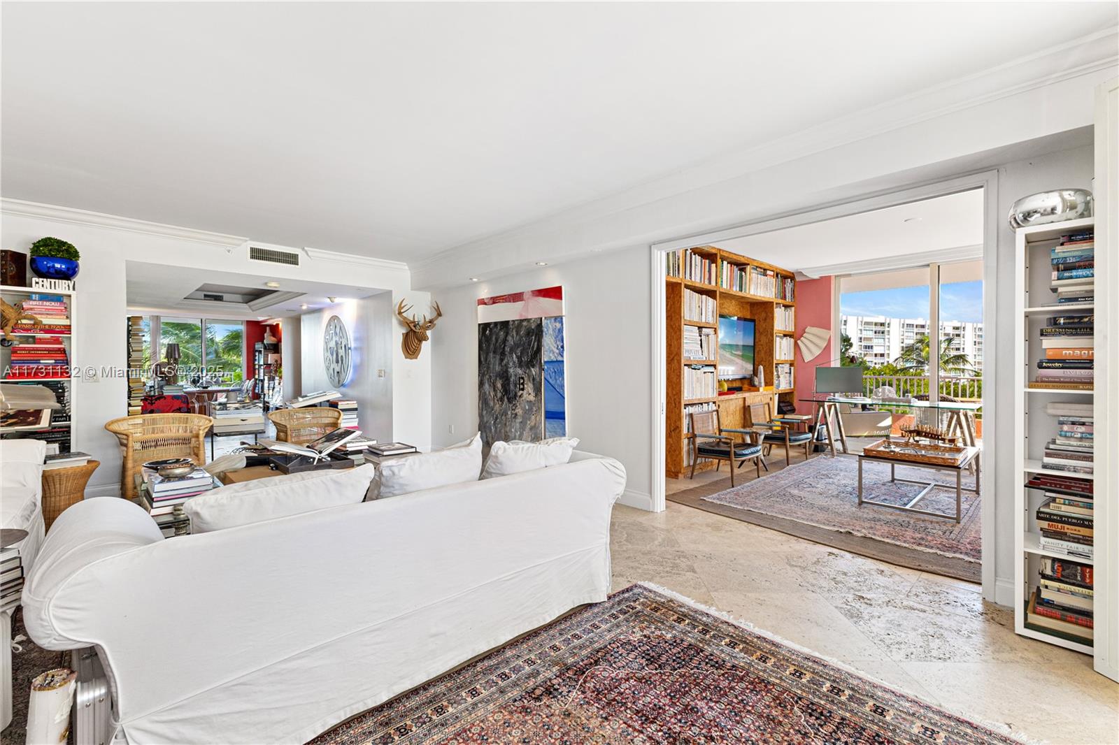 781 Crandon Boulevard, Unit 406 Key Biscayne, FL 33149 - Photo 16 of 35 a living room with furniture and a dining table with chairs