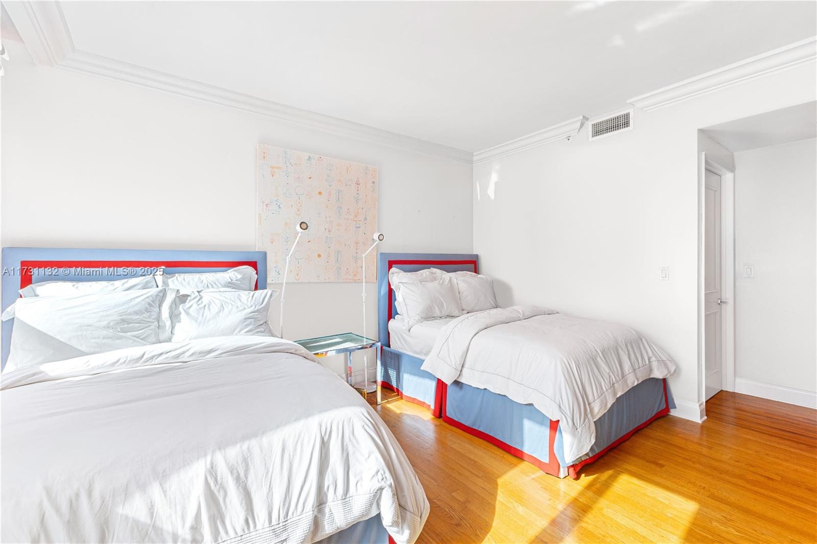 781 Crandon Boulevard, Unit 406 Key Biscayne, FL 33149 - Photo 23 of 35 a bedroom with two beds and painted walls