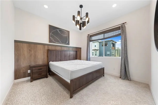 a spacious bathroom with a shower a sink and a mirror