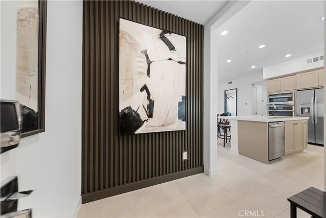 a view of kitchen with furniture and refrigerator